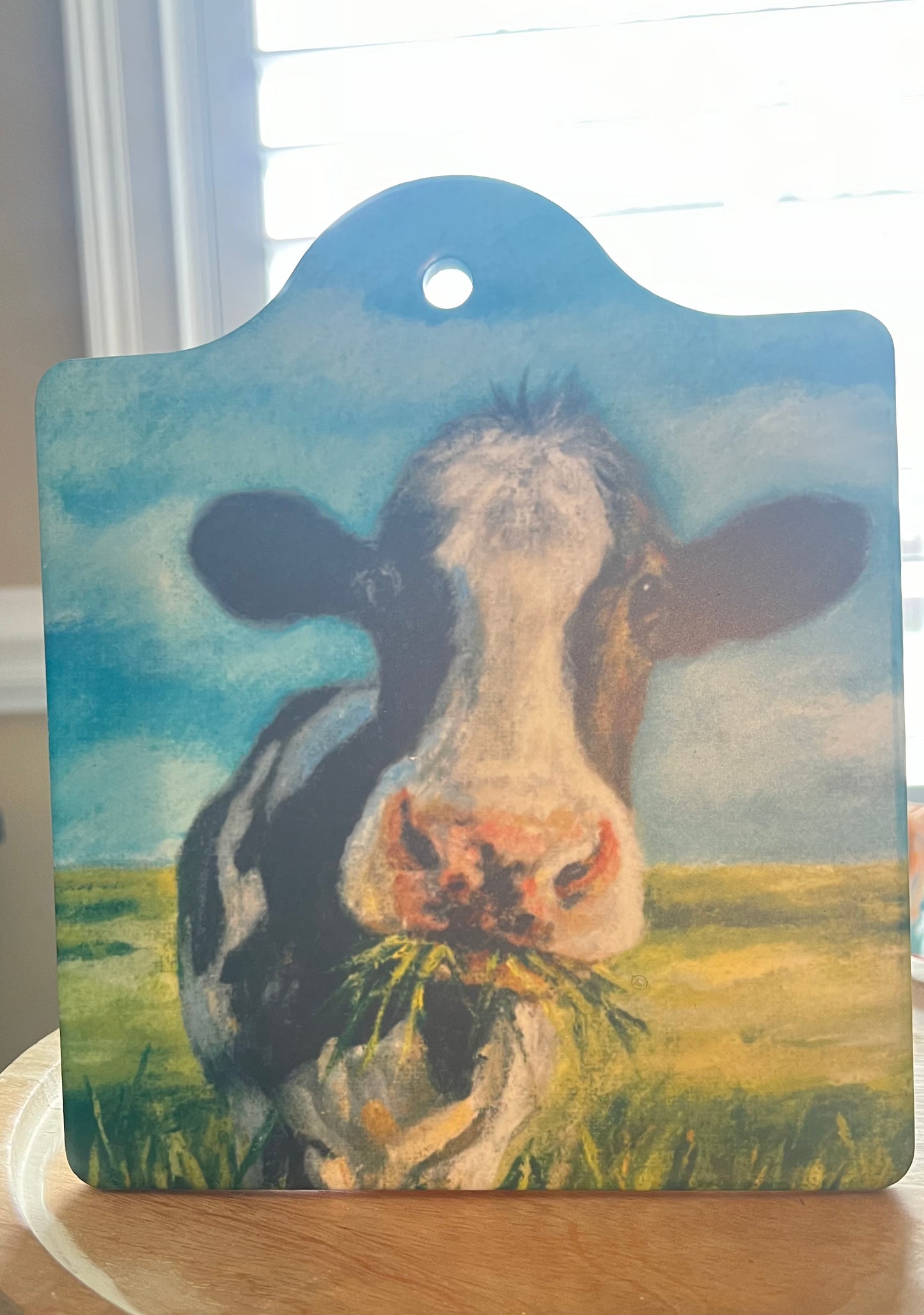Handmade stoneware trivet with cow eating grass design, cork-backed kitchen decor by MaryMoosCreations